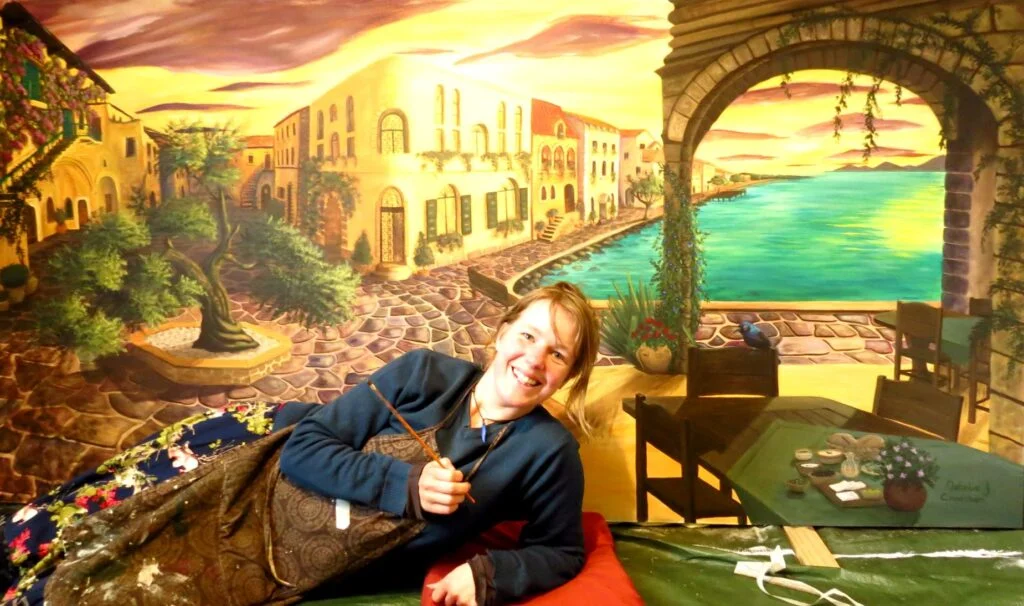 Natalie J Cheetham in front of her Mural